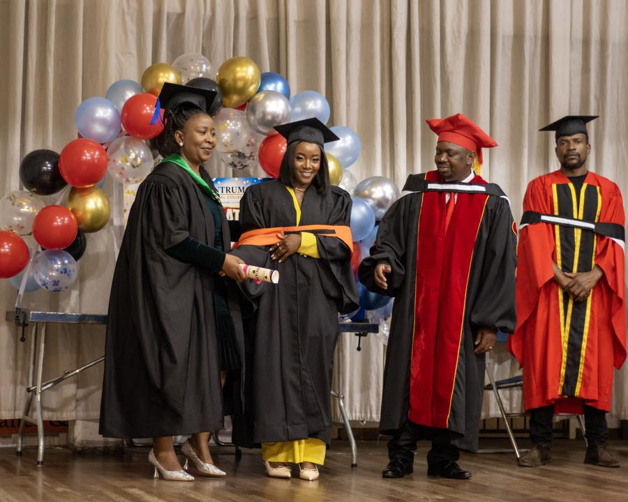 Graduate receiving her diploma on stage in Pretoria